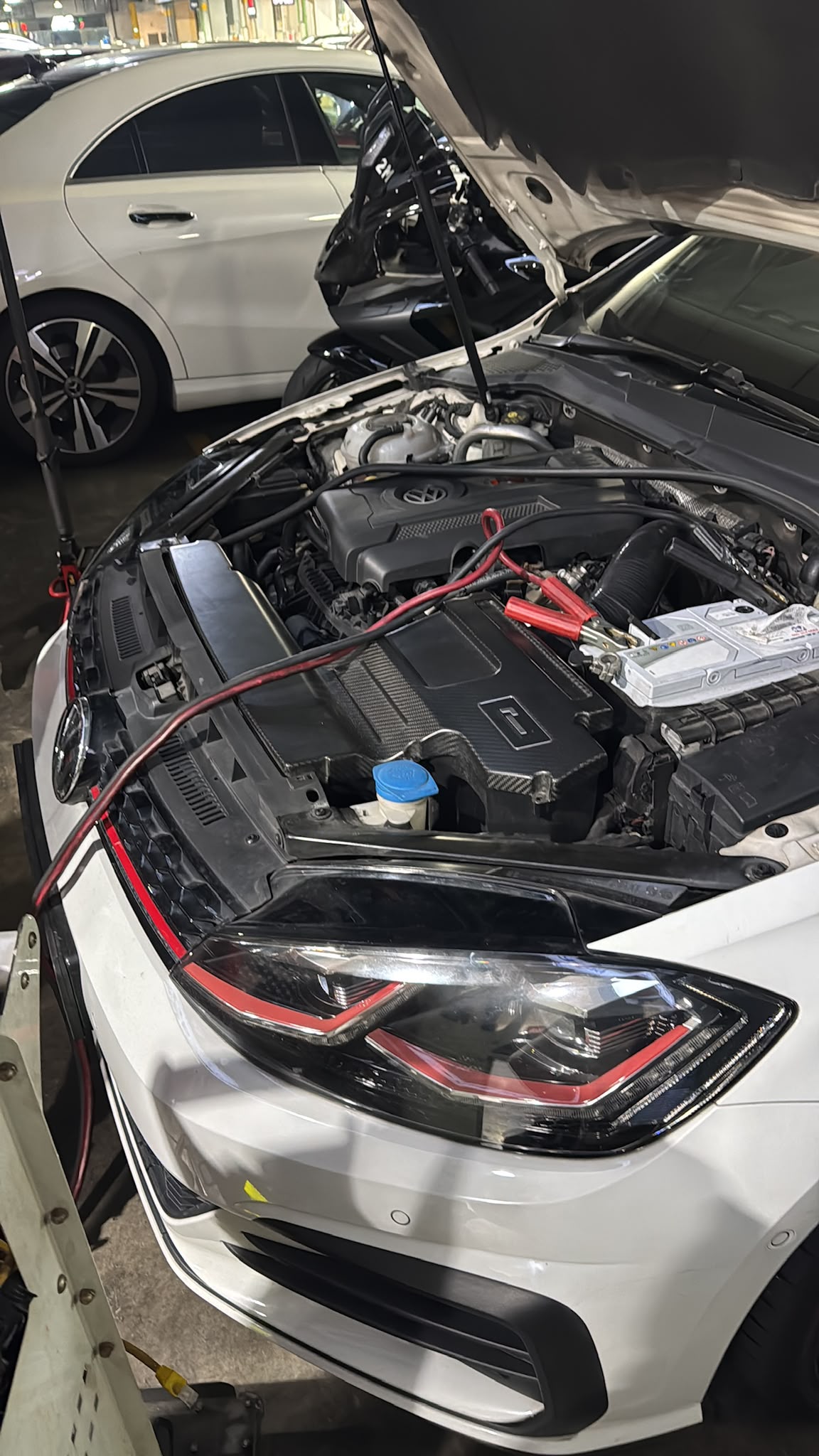 Volkswagen Golf with bonnet open receiving battery diagnostic check at TEC AUTO SERVICES independent workshop Singapore