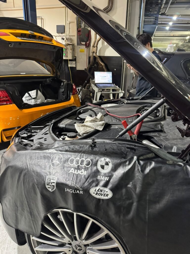 Mercedes-Benz car coding in Singapore with a stable power supply clamped on during programming