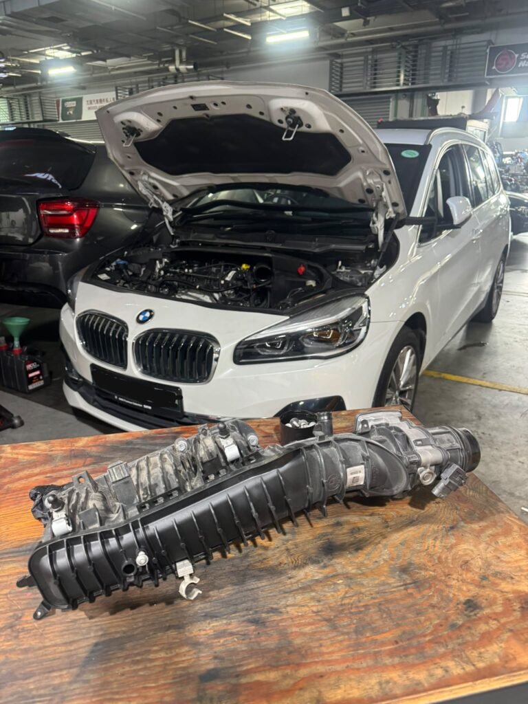 BMW 2 Series intake manifold removed BMW 2 Series with its intake manifold removed for carbon cleaning at a Woodlands workshop
