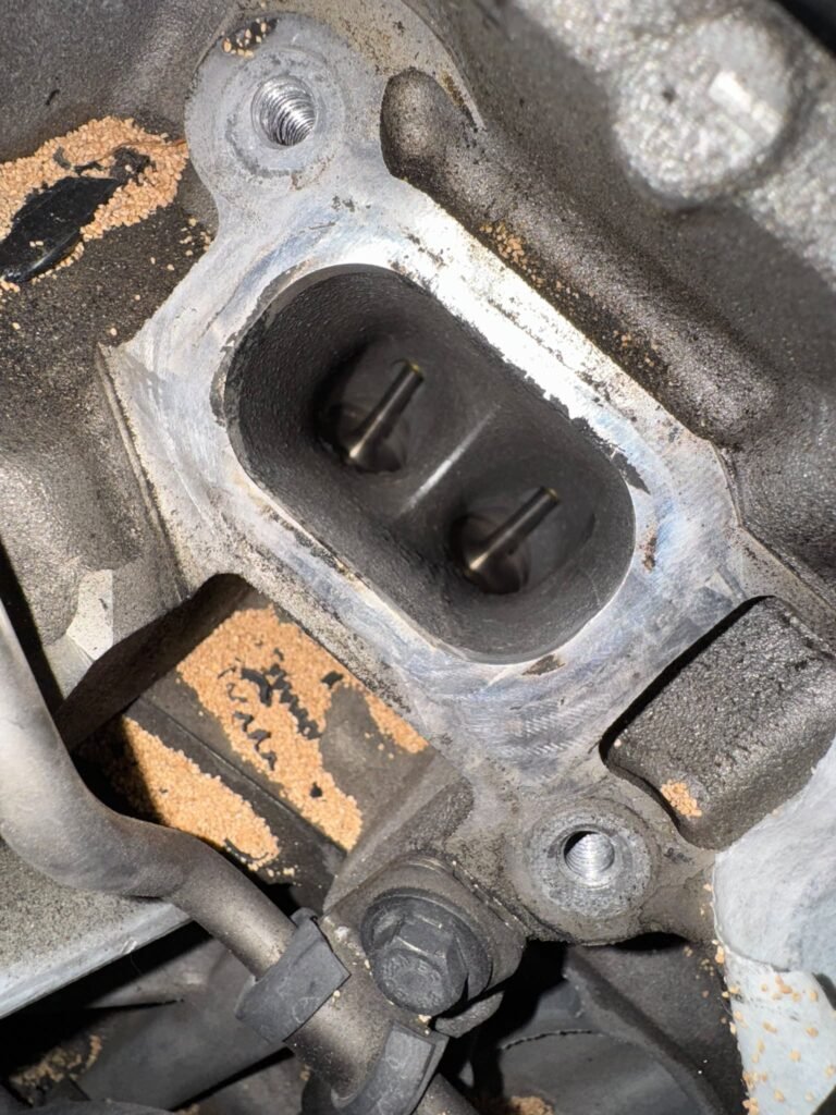 BMW N55 intake port and valves after walnut blasting, carbon removed, with walnut media visible