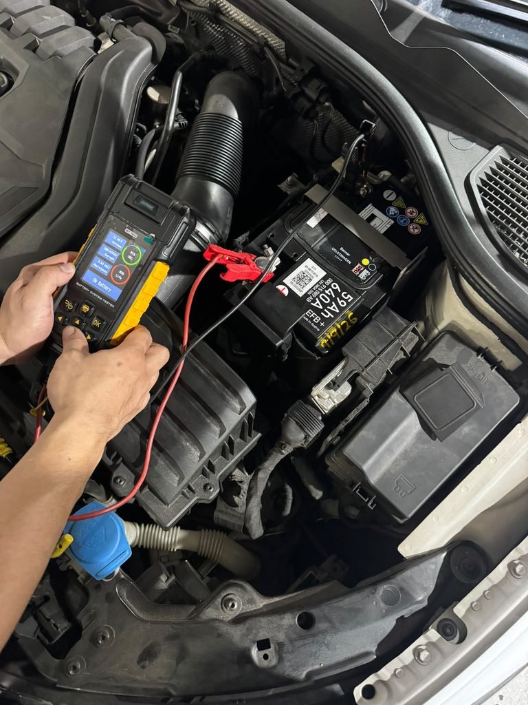 Battery tester checking a new start-stop battery after car battery replacement in Singapore